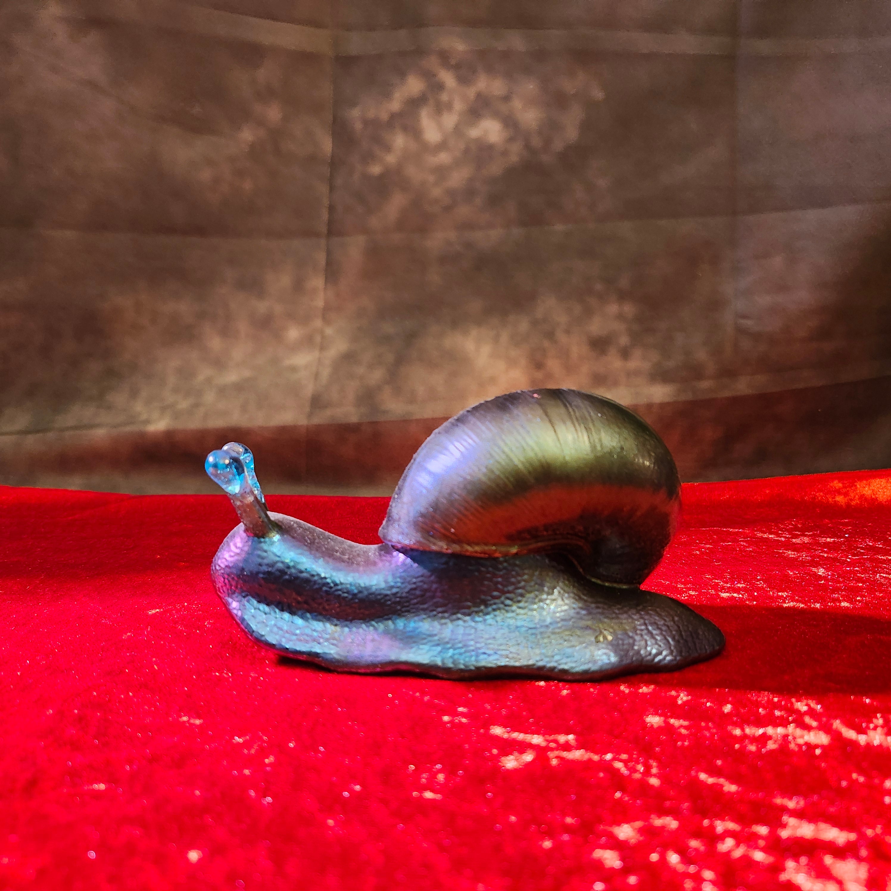 Solid hand-poured 3D resin fantasy snail sculpture featuring an iridescent metallic green shell, deep blue body, and translucent turquoise gemstone antennae.