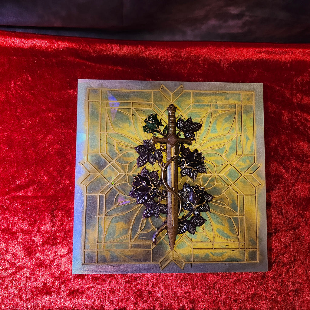 3D Art Nouveau resin relief panel featuring a sculpted medieval sword and dark roses overlaying a light-refracting gold and teal gothic cathedral geometric grid.