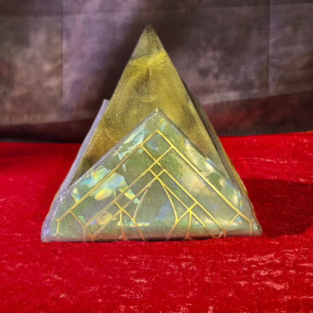 Solid hand-poured 3D resin pyramid sculpture featuring a shifting metallic gold peak, holographic teal base, and an Art Nouveau geometric line grid.